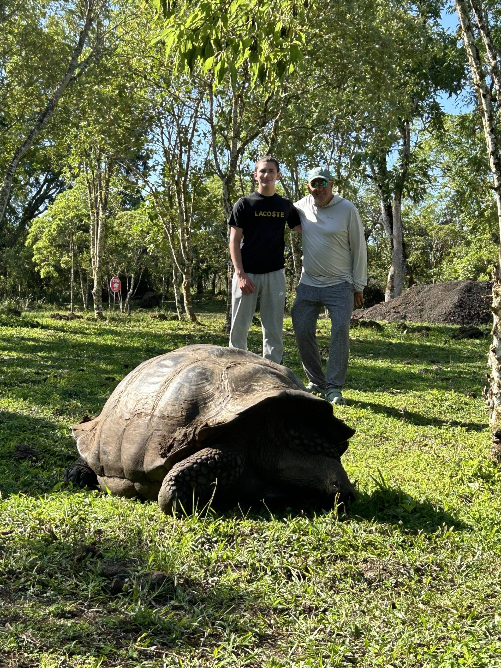 Father-son with giant tortoise